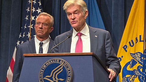 Mehmet Oz and Kennedy Jr giving speech on a podium of Department of Health and Human Services.