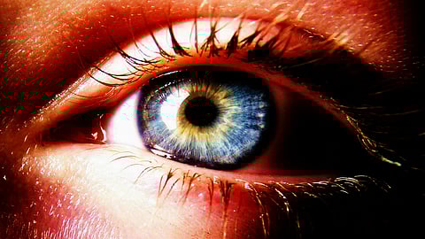 a close up of a person's blue eye