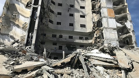 A collapsed building with a lot of debris is visible.