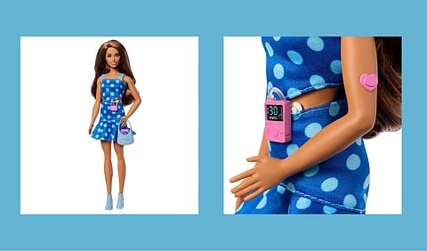 A newly launched Type-1 diabetes Barbie in a blue polka dot dress with a bag and monitor.