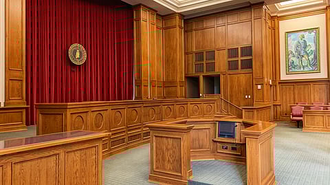 An empty courtroom with complete wooden panelling.
