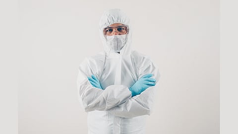 A doctor is seen wearing a PPE kit.
