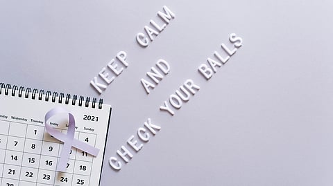 A calender with words written Keep calm and check your balls.