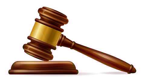 Wooden gavel resting on a plain white background, symbolizing authority and justice.