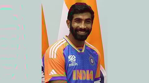 Picture of Jasprit Bumrah wearing the Indian Cricket Team jersey and smiling at the camera.