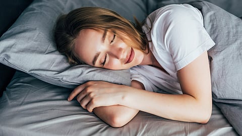 The image shows a woman sleeping.