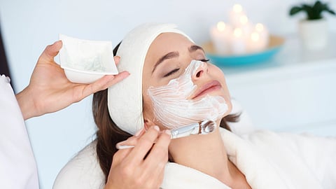 A woman undergoing a facial in a clinic.