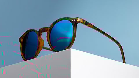 A blue tinted sunglasses with brown frame.