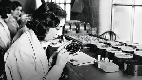A woman in a 1920s factory painting watch dials with radium-based luminous paint.