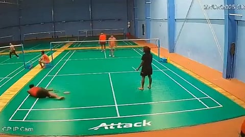 Man falls down while playing Badminton