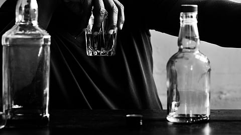 Illustration of man struggling with alcohol addiction.