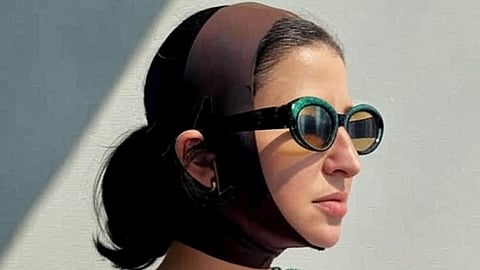 Image depicting woman wearing a SKIMS face wrap.