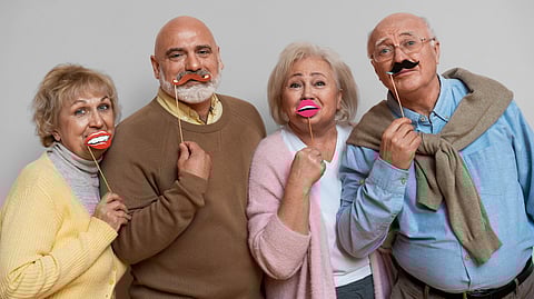 A group of happy and cheerful old people holding in hand.