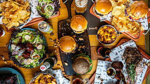 Image showing various junk foods  like pizza, burger, chips, etc. One of the leading reason behind weight gain.