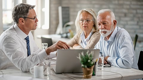 Mature couple getting a counselling from a business manager to help them.