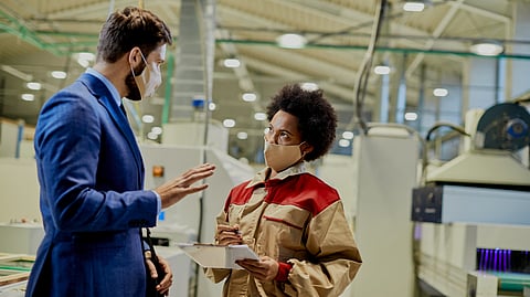 Manager and a worker discussing about the issues related to GxP.