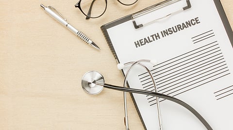 A clipboard showing health insurance, pen and a stethoscope.