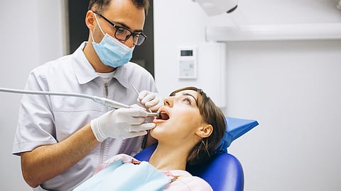 Dentist providing orthodontic care to a patient in clinic.