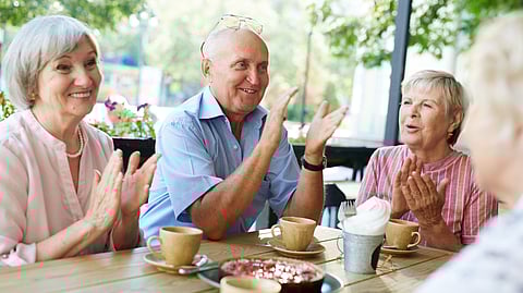 A group of elderly people at a table.