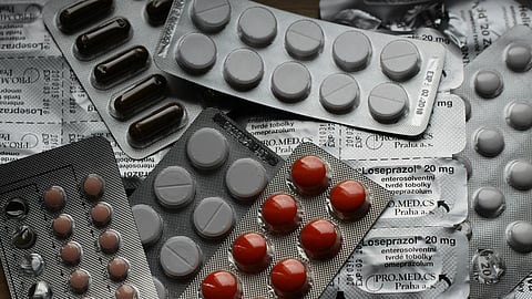 different medicine strips on grey background
