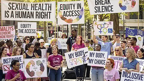 Demonstrators with signs advocating for sexual health, rights, and justice, including people in wheelchairs.