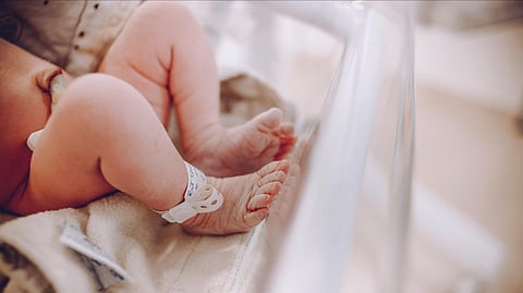 legs of an infant on hospital bed