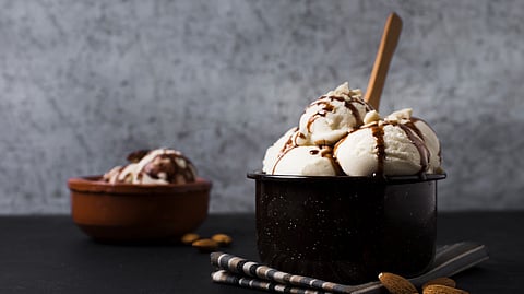 Image of an ice-cream with chocolate as toppings.
