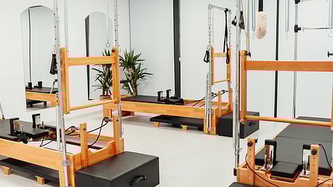 Image of a Pilates studio having equipment for sustainable strength training.