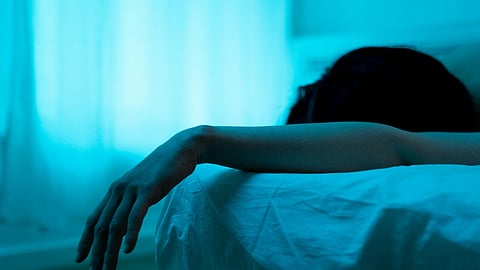 a women sleeping on bed, with one hand out