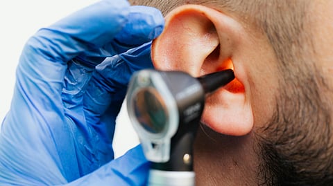 close up of an ear checkup and the device