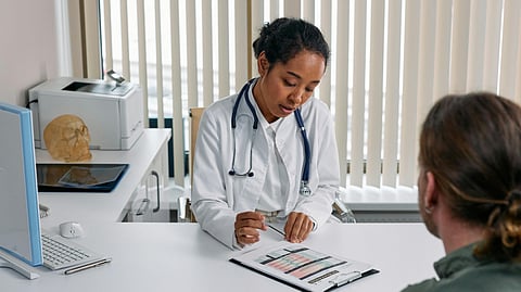 A doctor and a patient sitting in a clinic.
