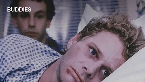 Image of a person having wounds on his face and in a lying in a resting position in his bed.