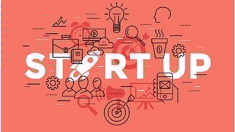 Image showing graphics having start up written on it in front of a peach background.