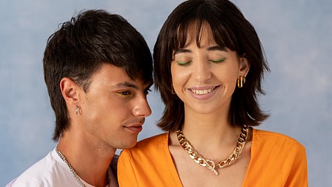 Image of a couple in a very intimate situation in front of a blue background.
