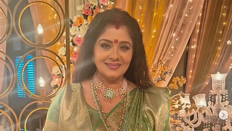 An image of Sudha Chandran in a green saree.