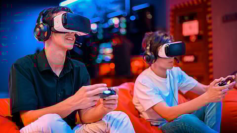 two boys one in black shirt and other in white t shirt playing virtual reality game using virtual headset and headphones 