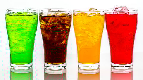 Image of four colorful sugary soda drinks.