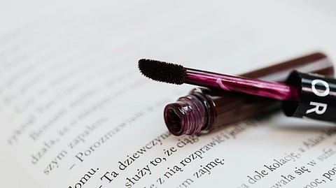 An image of a lipcolour opened on a book.