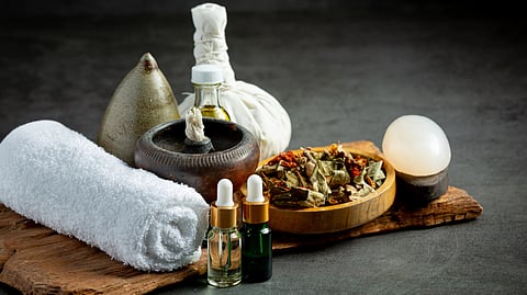 A set of ayurvedic medicine and a white towel.