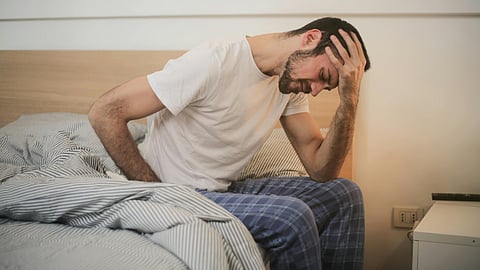 An image of a man experiencing back ache.
