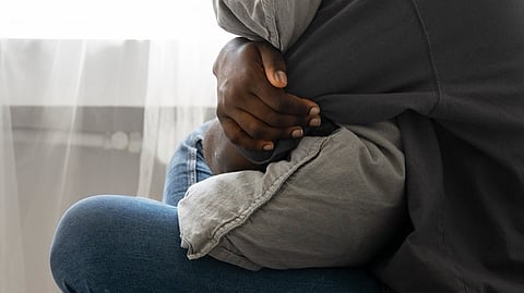 Image of a boy having pillows in his hand.