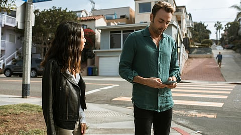 An image of a couple, the guy looking at the phone and the girl being angry.