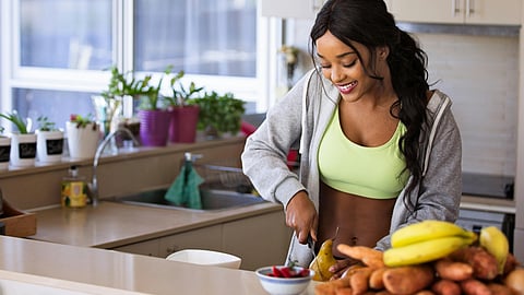 Image of a women making healthy dishes in the kitchen.