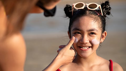 Image of a mother applying sunscreen to her daughter.