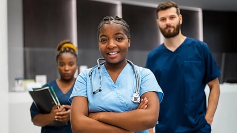Three nurses (one male and 2 females) posing for the photograph.