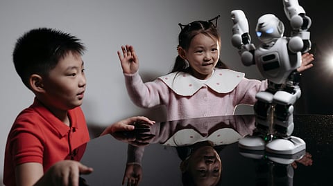 Image showing children dancing with a robot.