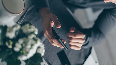 Image of a person using a phone.