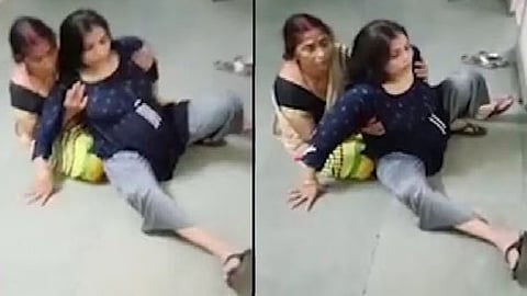 An image of a woman in distress on floor along with a relative.