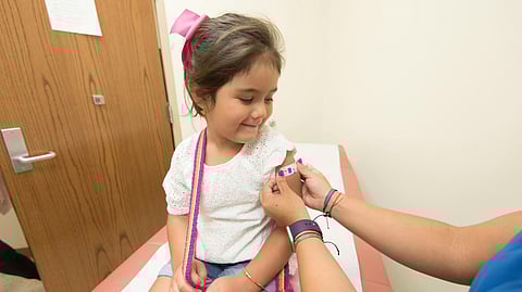 An image of a girl getting vaccinated.