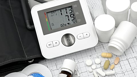 An image of a blood pressure machine and pills.